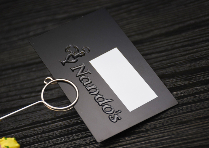 Matte black metal card, deep etched with black printing