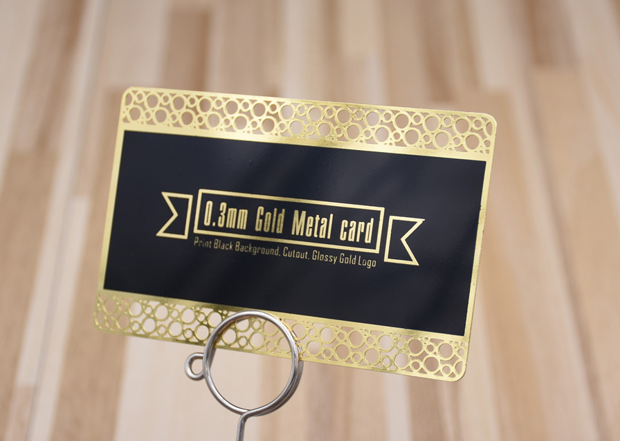 Glossy gold metal card, cutout lace, print black background, glossy gold logo