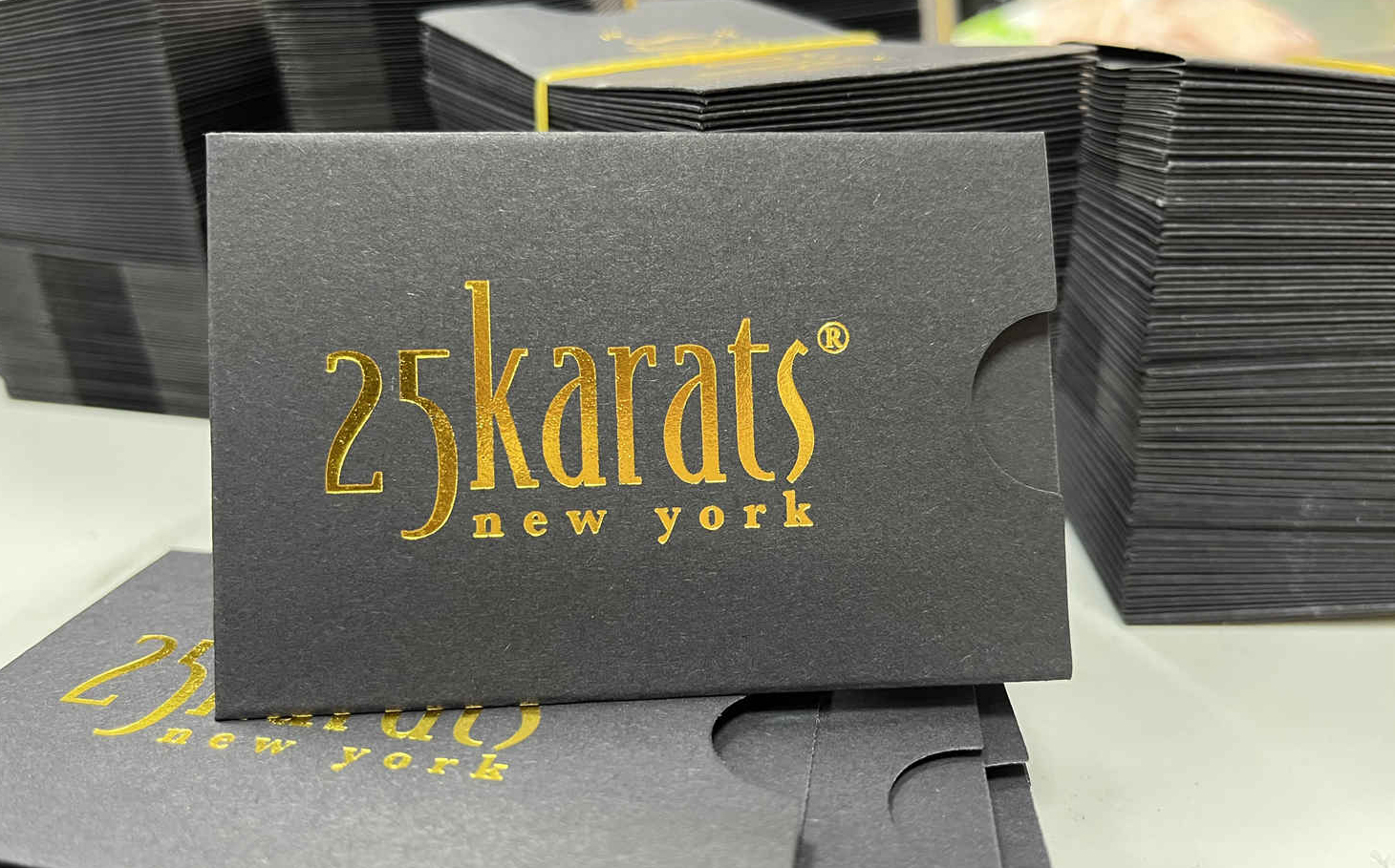 Black card sleeves, 60x90mm, gold foil stamped logo